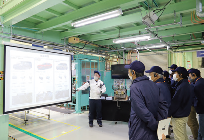 工場見学会で、工程の説明を聞かれる個人株主さま